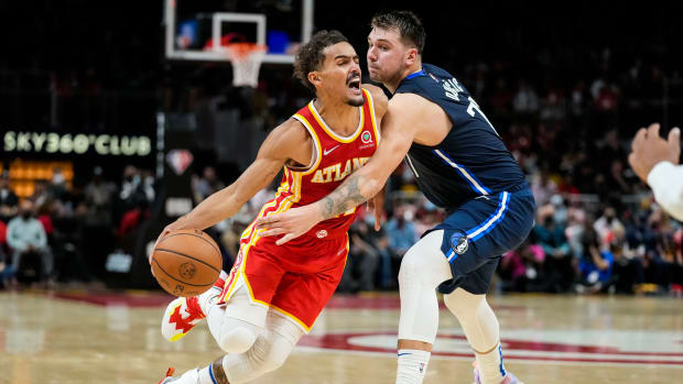 Atlanta Hawks guard Trae Young (11) dribbles against Dallas Mavericks guard Luka Doncic (77) during the second half at State Farm Arena.